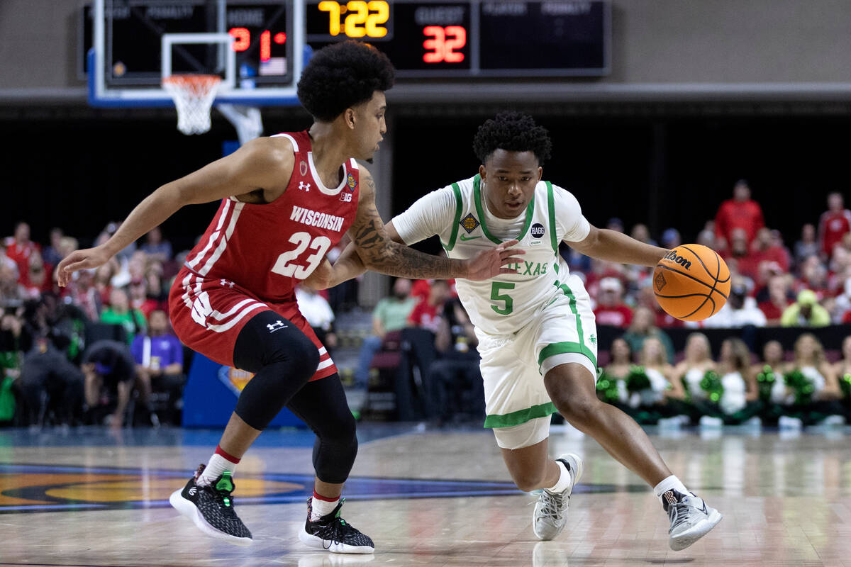 North Texas Mean Green guard Tylor Perry (5) drives toward the hoop around Wisconsin Badgers gu ...