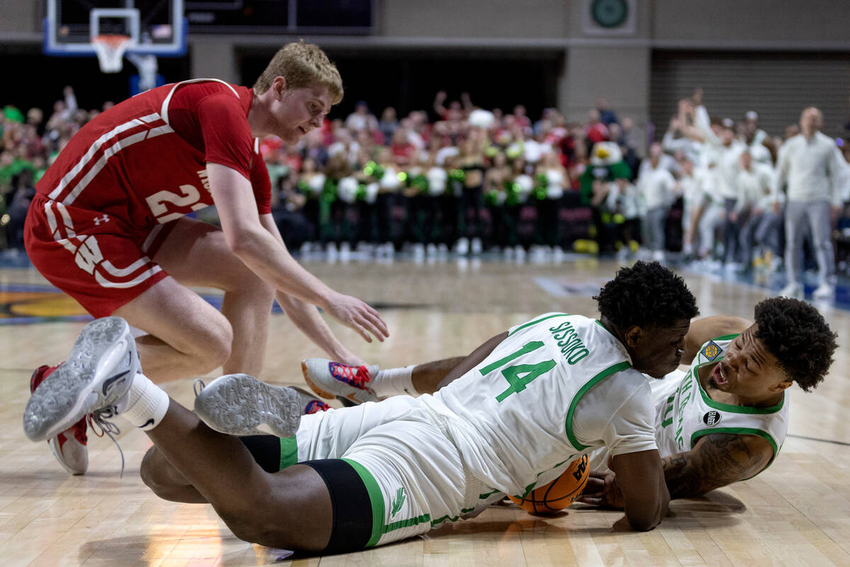 North Texas Mean Green forward Moulaye Sissoko (14) and guard Kai Huntsberry (10) dive for poss ...