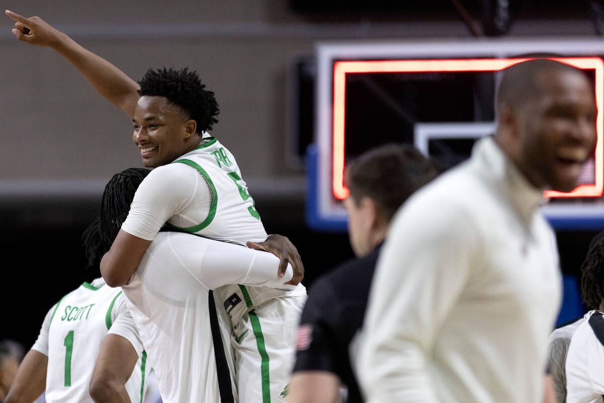 North Texas Mean Green guard Tylor Perry (5) and his team celebrate after winning a NCAA colleg ...