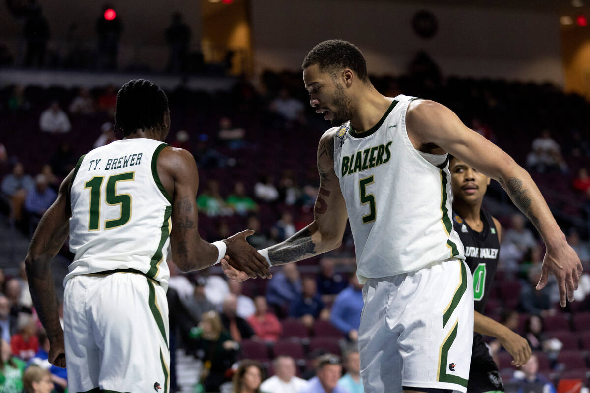 UAB Blazers forward Ty Brewer (15) and forward KJ Buffen (5) slap hands during the first half i ...