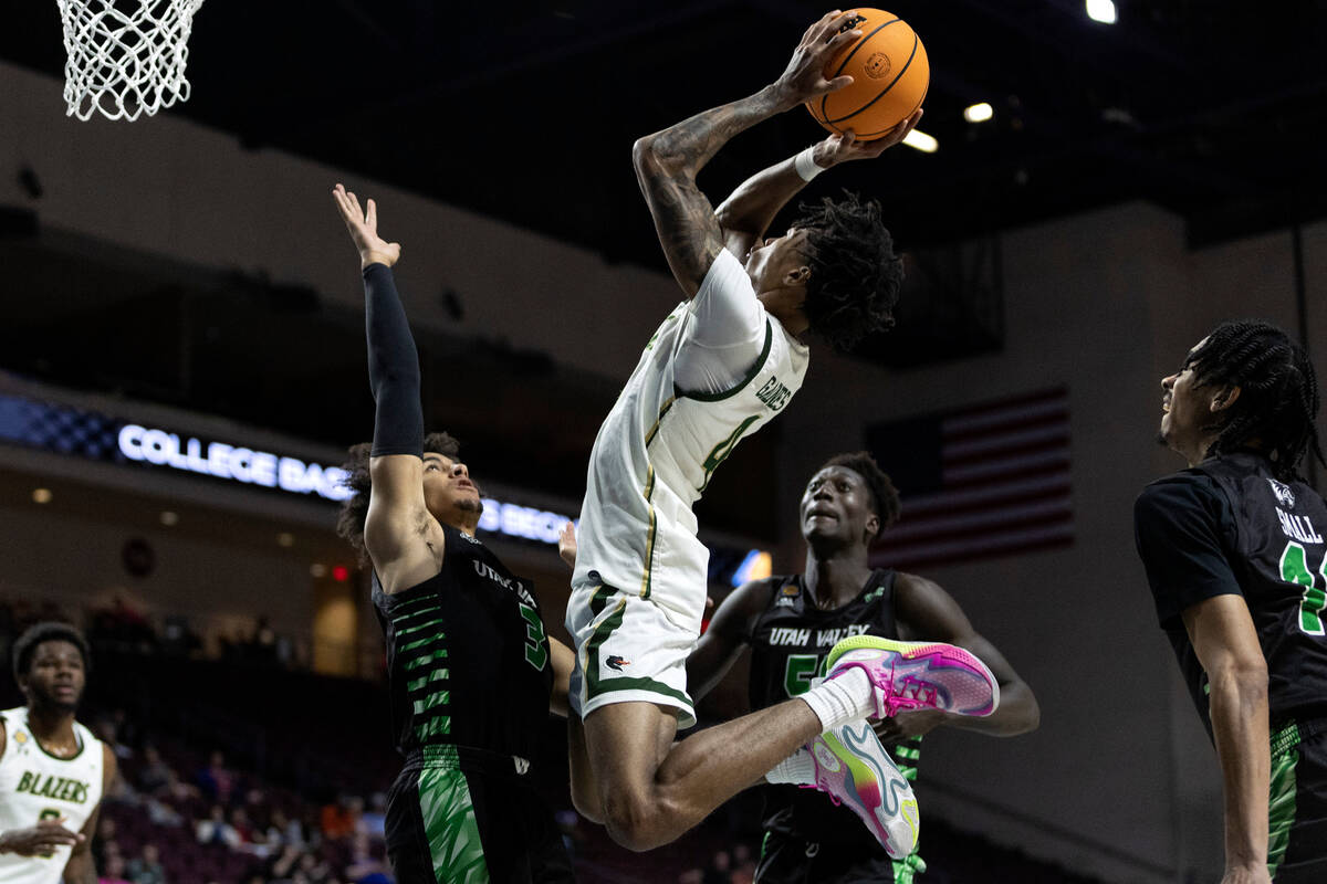 UAB Blazers guard Eric Gaines (4) shoots against Utah Valley Wolverines guard Blaze Nield (3) a ...