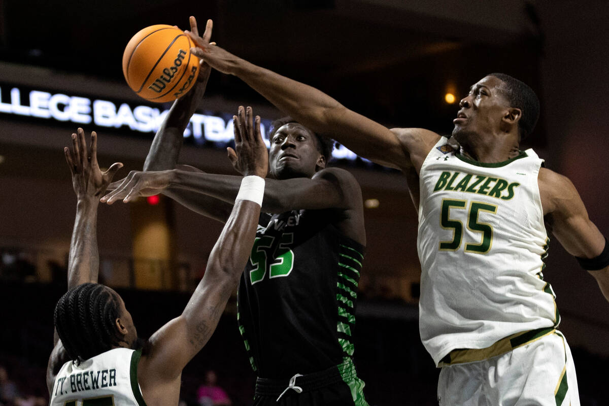 Utah Valley Wolverines center Aziz Bandaogo (55) shoots while UAB Blazers forward Ty Brewer (15 ...