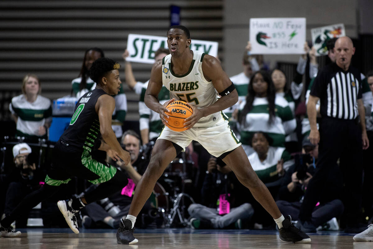 UAB Blazers center Trey Jemison (55) looks to pass while Utah Valley Wolverines guard Justin Ha ...