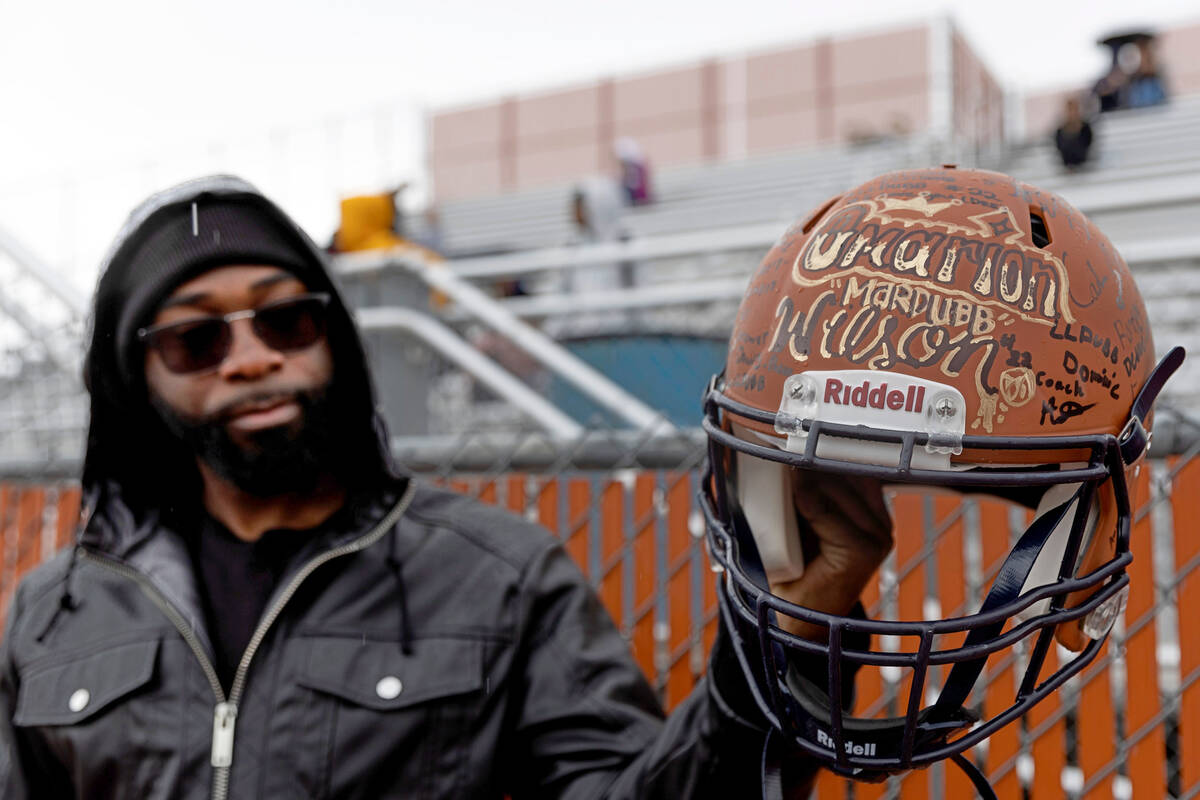 Jeremiah Wiggins, uncle of Omarion Wilson, shows his football helmet which was signed by his te ...