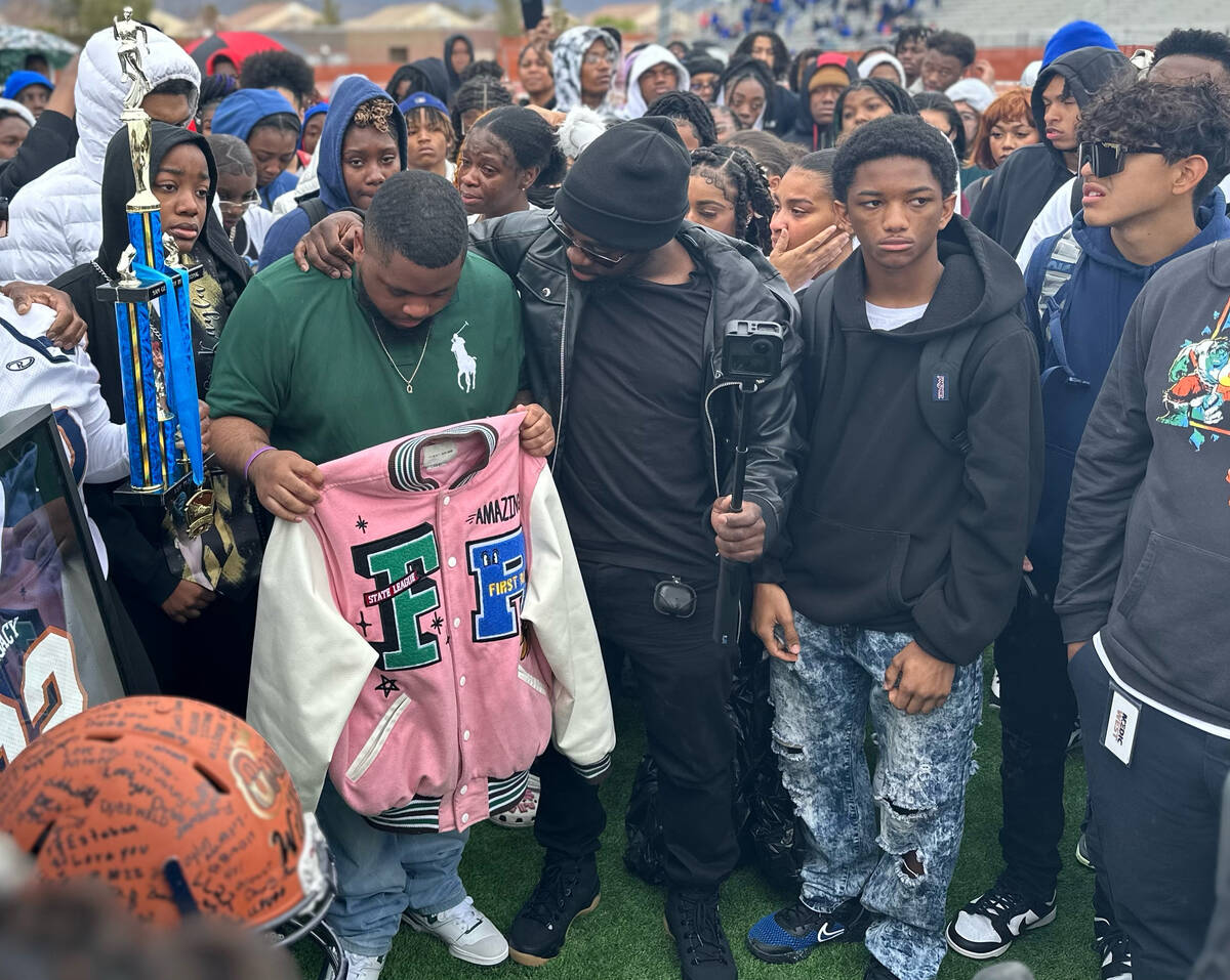 Quan Britton, 23, holds his brother Omarion Wilson’s pink jacket as Jeremiah Wiggins, th ...
