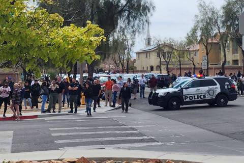 People wait outside of Shadow Ridge High School during a lockdown, Wednesday, March, 29, 2023, ...