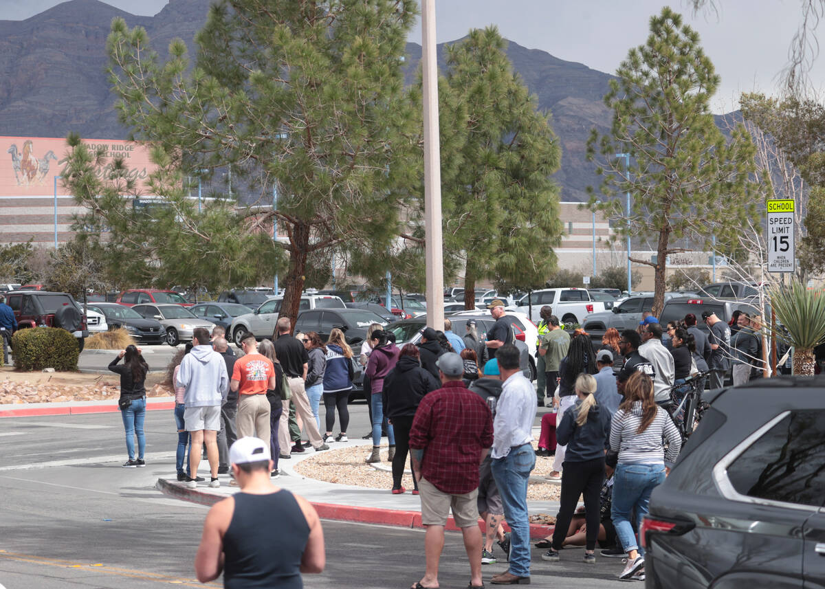 Parents wait outside of Shadow Ridge High School as Las Vegas police investigate after a threat ...