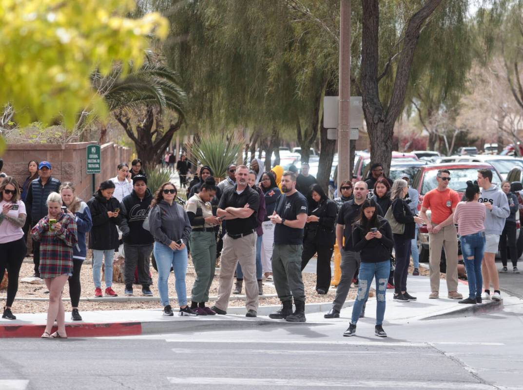 Parents wait outside of Shadow Ridge High School as Las Vegas police investigate after a threat ...