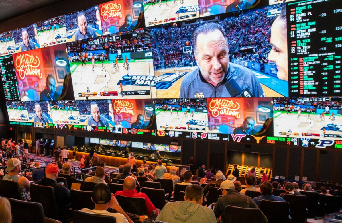 Fans watch games during March Madness at the Circa Sportsbook in March 2022 in Las Vegas. (Bizu ...
