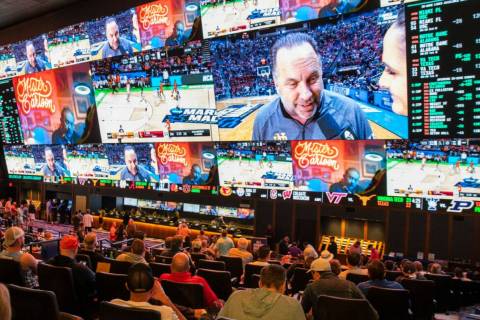 Fans watch games during March Madness at the Circa Sportsbook in March 2022 in Las Vegas. (Bizu ...