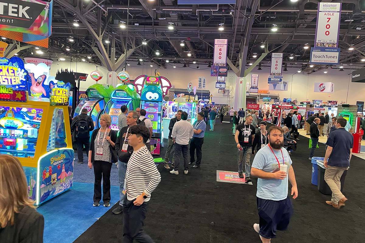 Attendees roam the exhibit hall during the Amusement Expo International on Tuesday, March 28, 2 ...