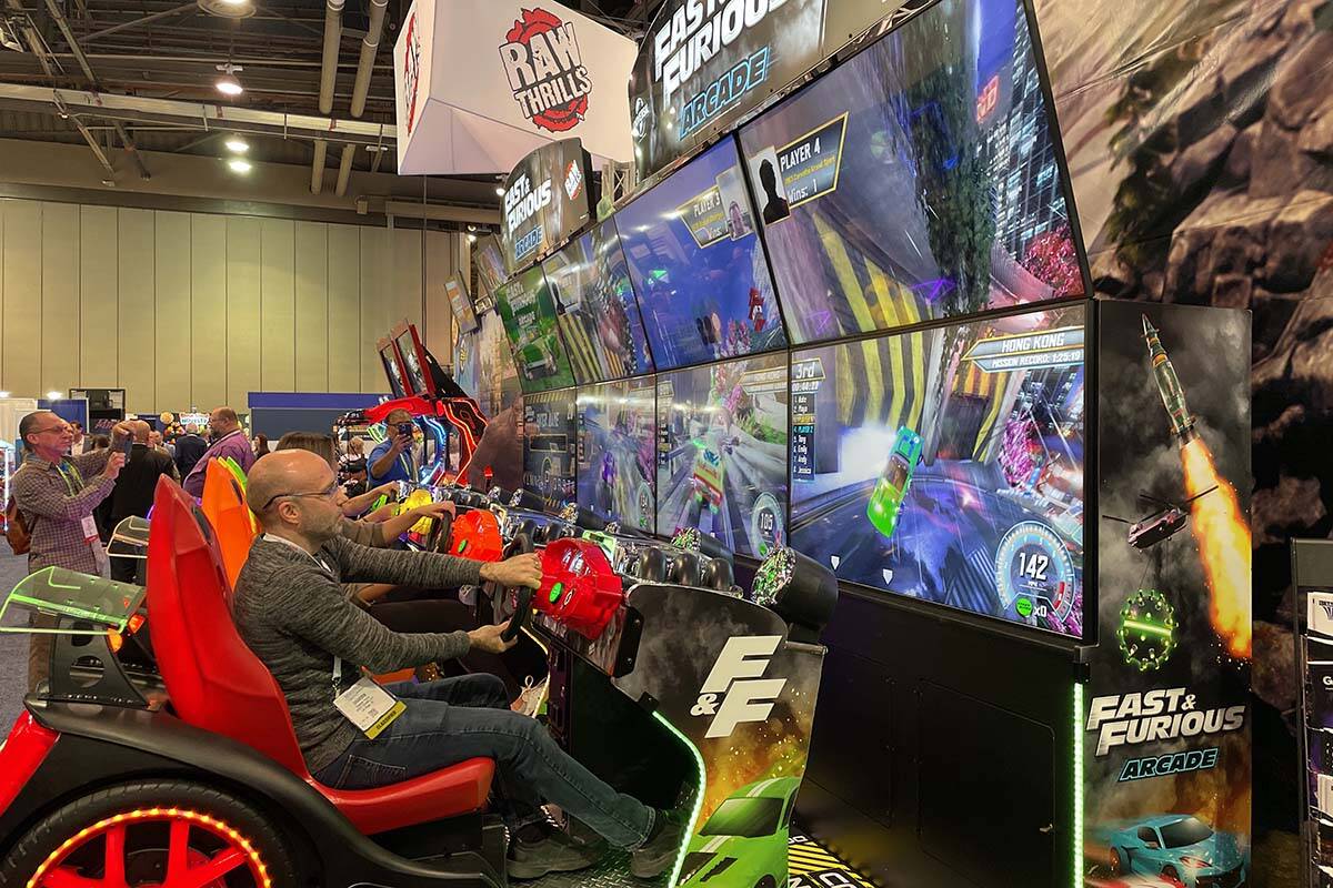Las Vegas resident Brandon Pertile tries out a Fast and Furious arcade game during the Amusemen ...