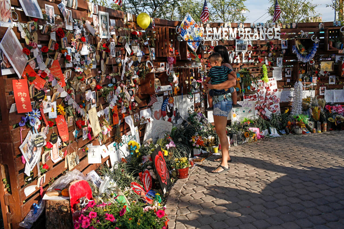 People visit a memorial at the Las Vegas Community Healing Garden in Las Vegas, Monday, Oct. 16 ...