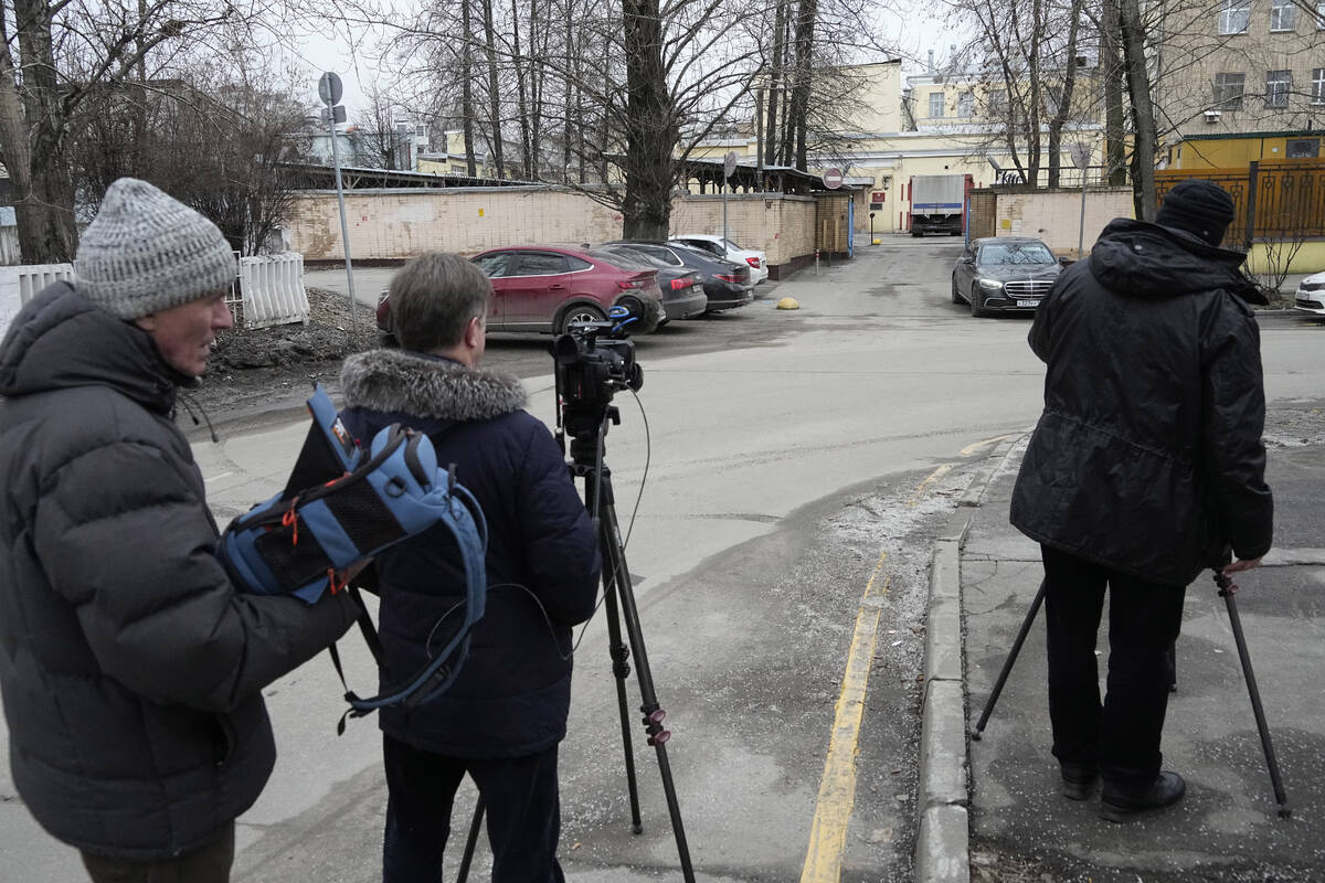 Journalists stand next to an entrance of the Lefortovo prison, in Moscow, Russia, Thursday, Mar ...