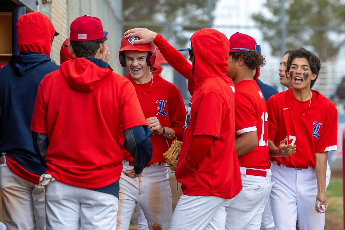 Liberty runner Cole Neilson is congratulated on a score versus Spring Valley during the third i ...