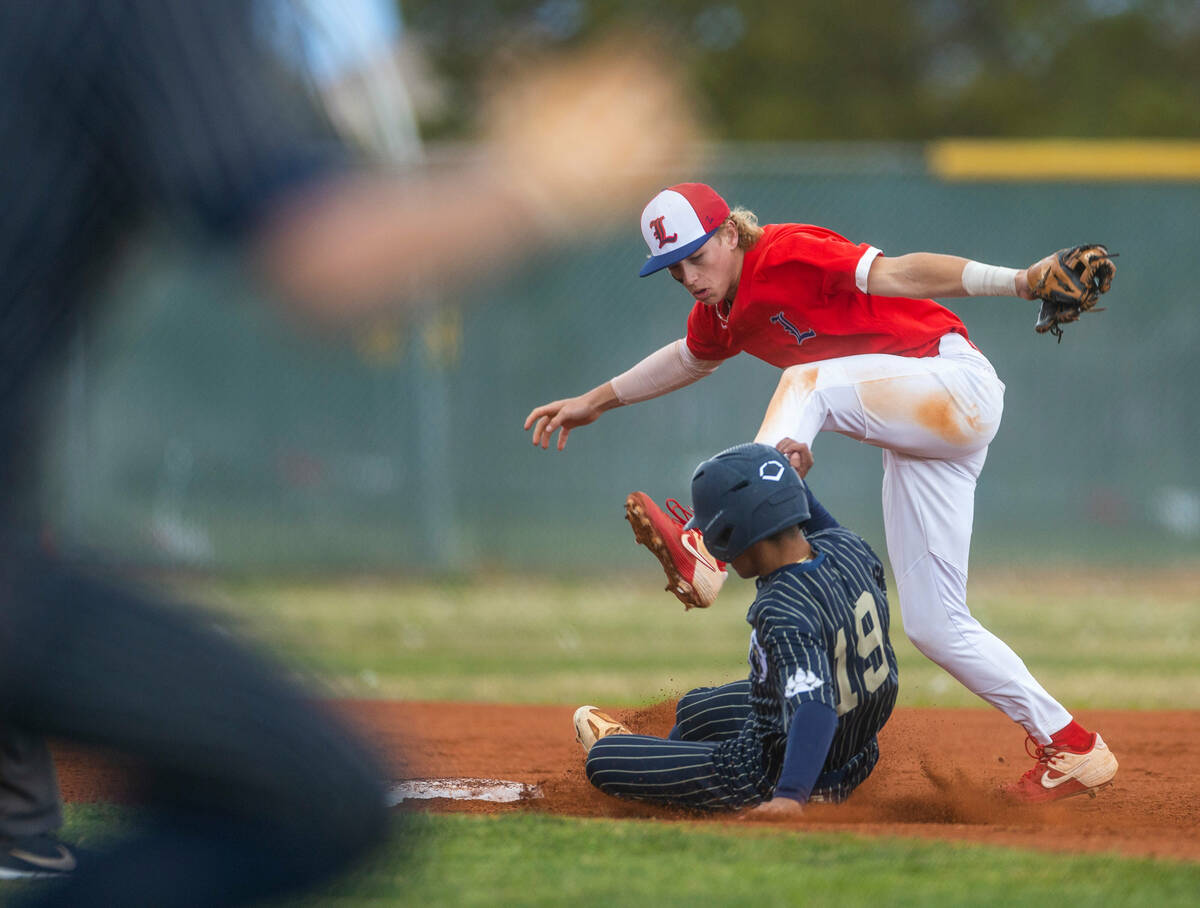Liberty second baseman Konner Brown misses a catch as Spring Valley runner Aidrik Teal slides s ...
