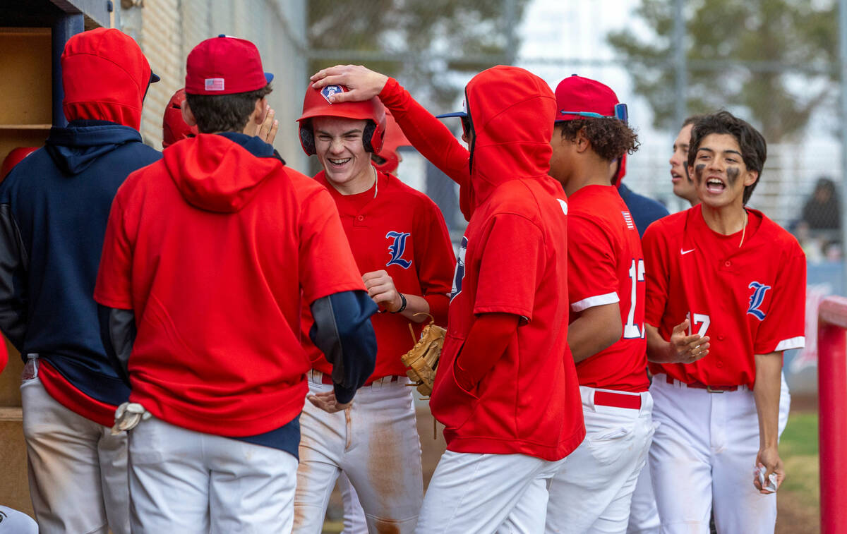 Liberty runner Cole Neilson is congratulated on a score versus Spring Valley during the third i ...