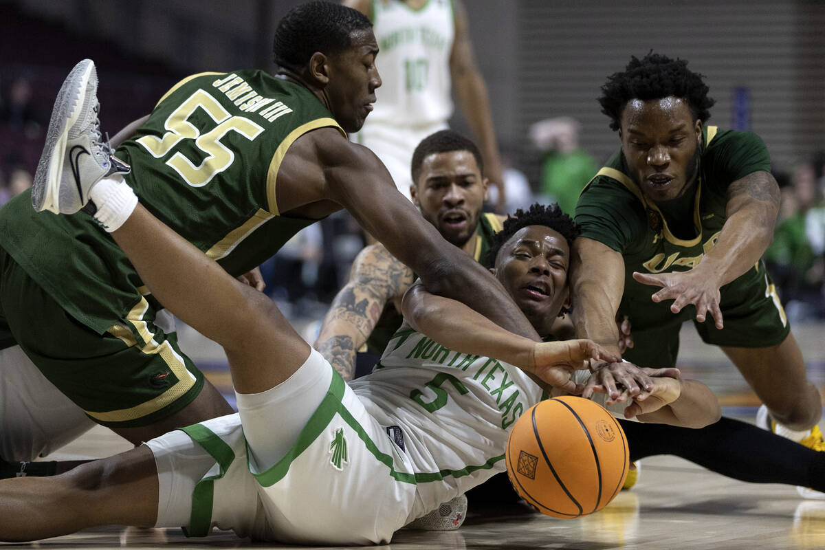 North Texas Mean Green guard Tylor Perry (5) dives to keep possession on offense while UAB Blaz ...