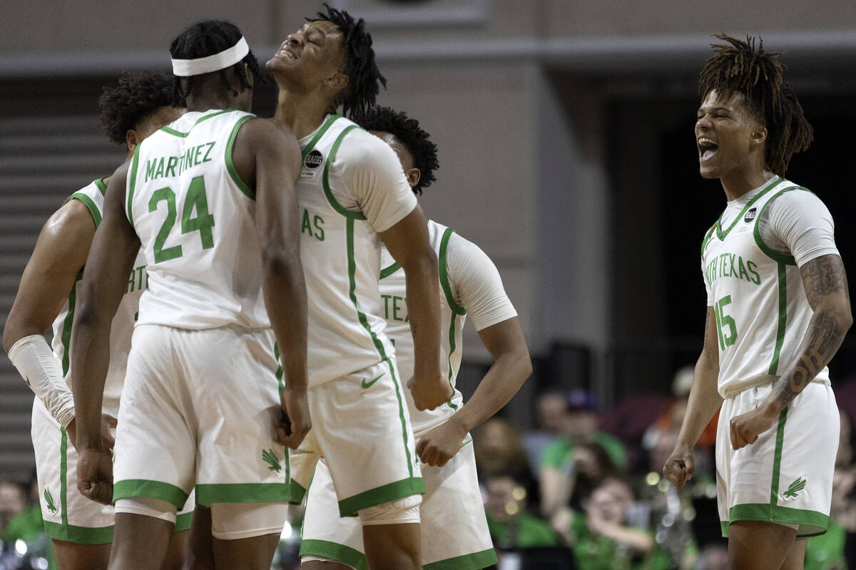 North Texas Mean Green forward Jayden Martinez (24), guard Aaron Scott, second from left, and g ...