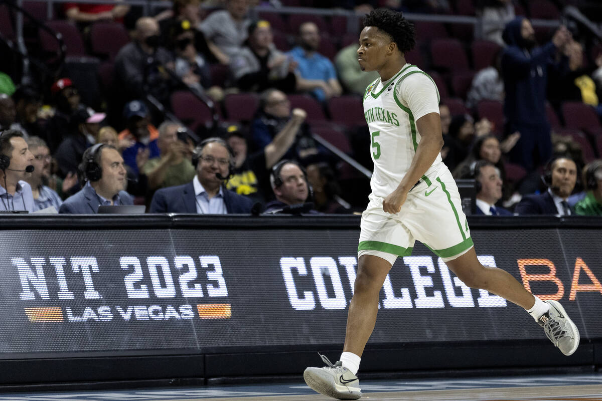 North Texas Mean Green guard Tylor Perry, tournament MVP, celebrates after scoring the three-po ...