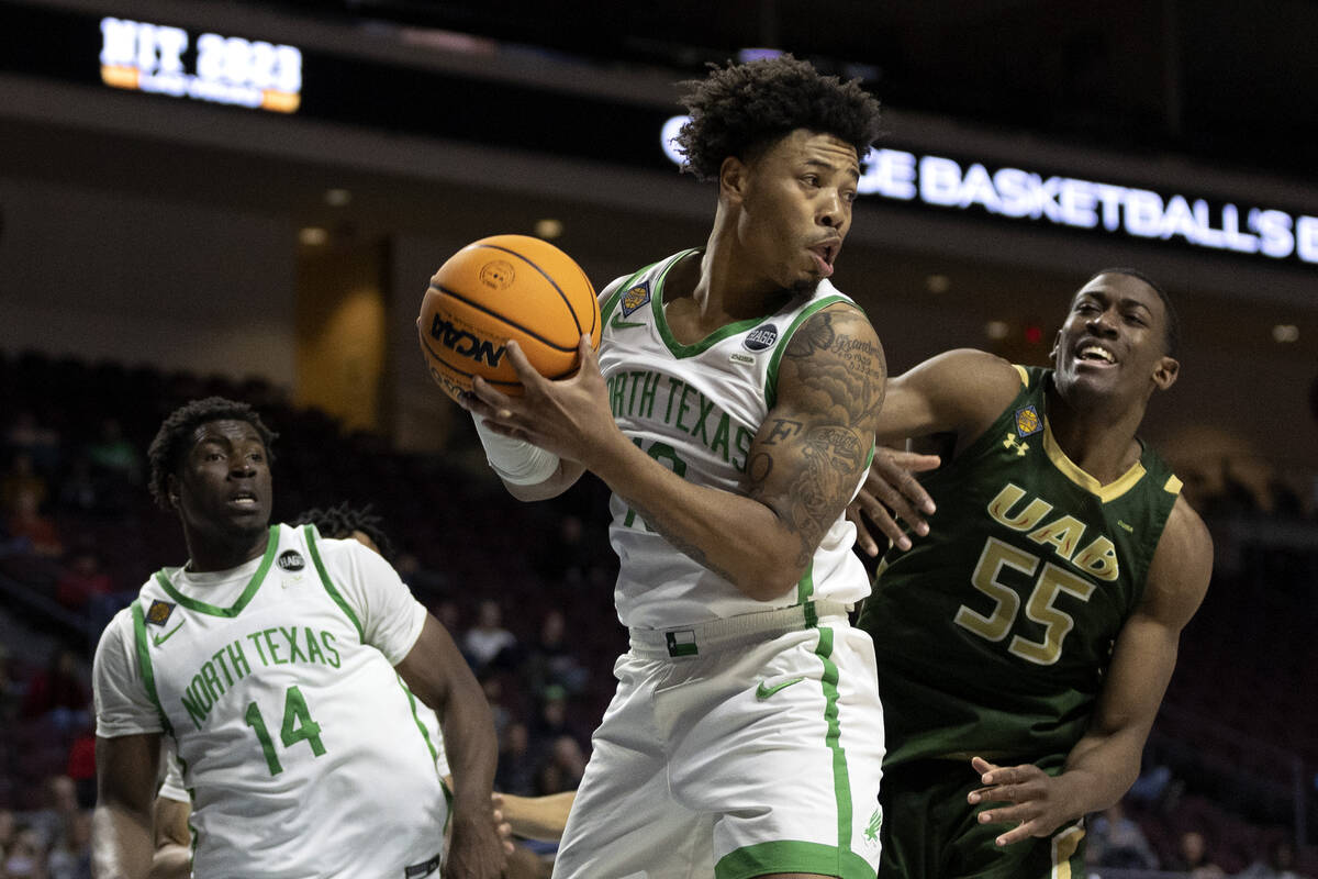 North Texas Mean Green guard Kai Huntsberry (10) secures the rebound on a shot by UAB Blazers c ...
