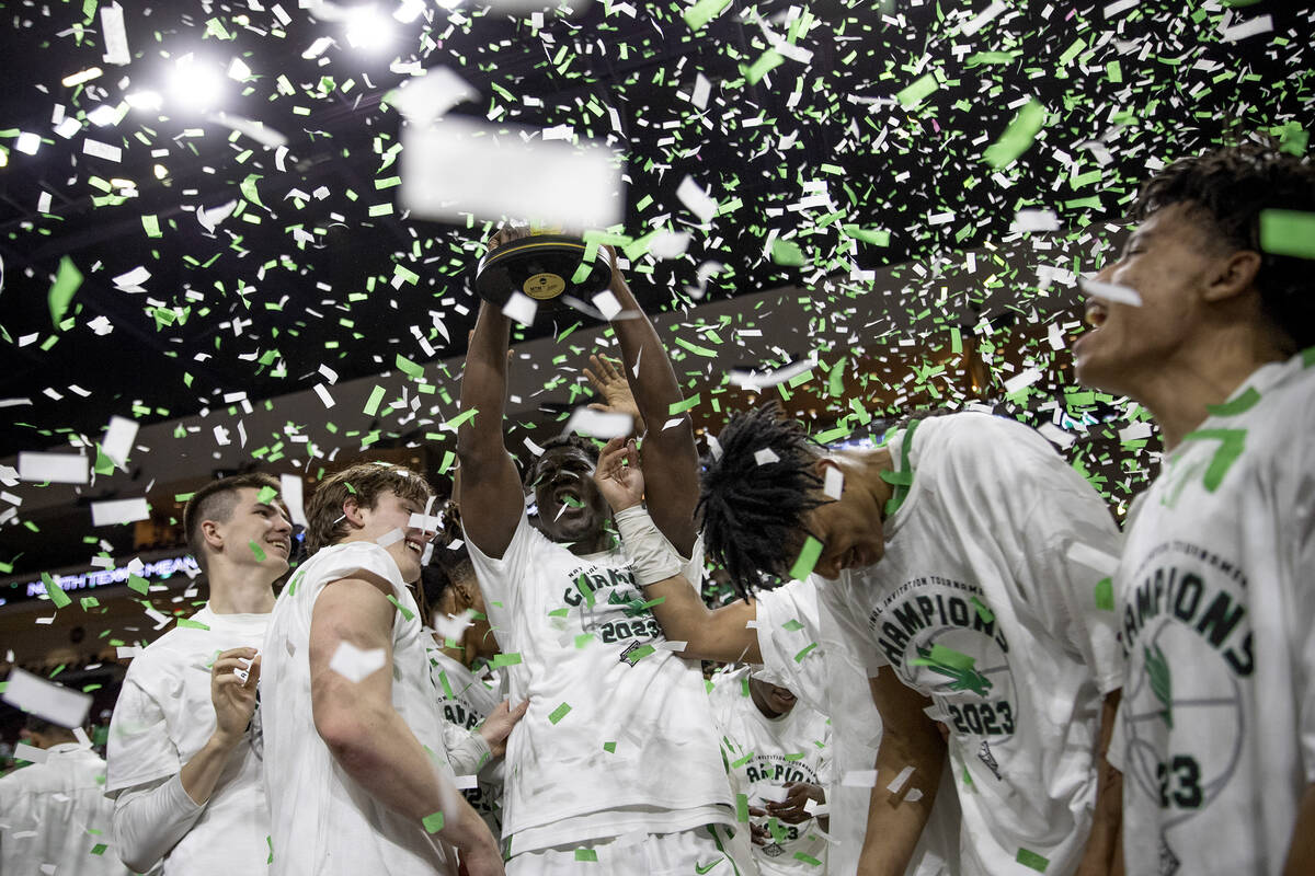 The North Texas Mean Green hold up their trophy after their team won the National Invitation To ...