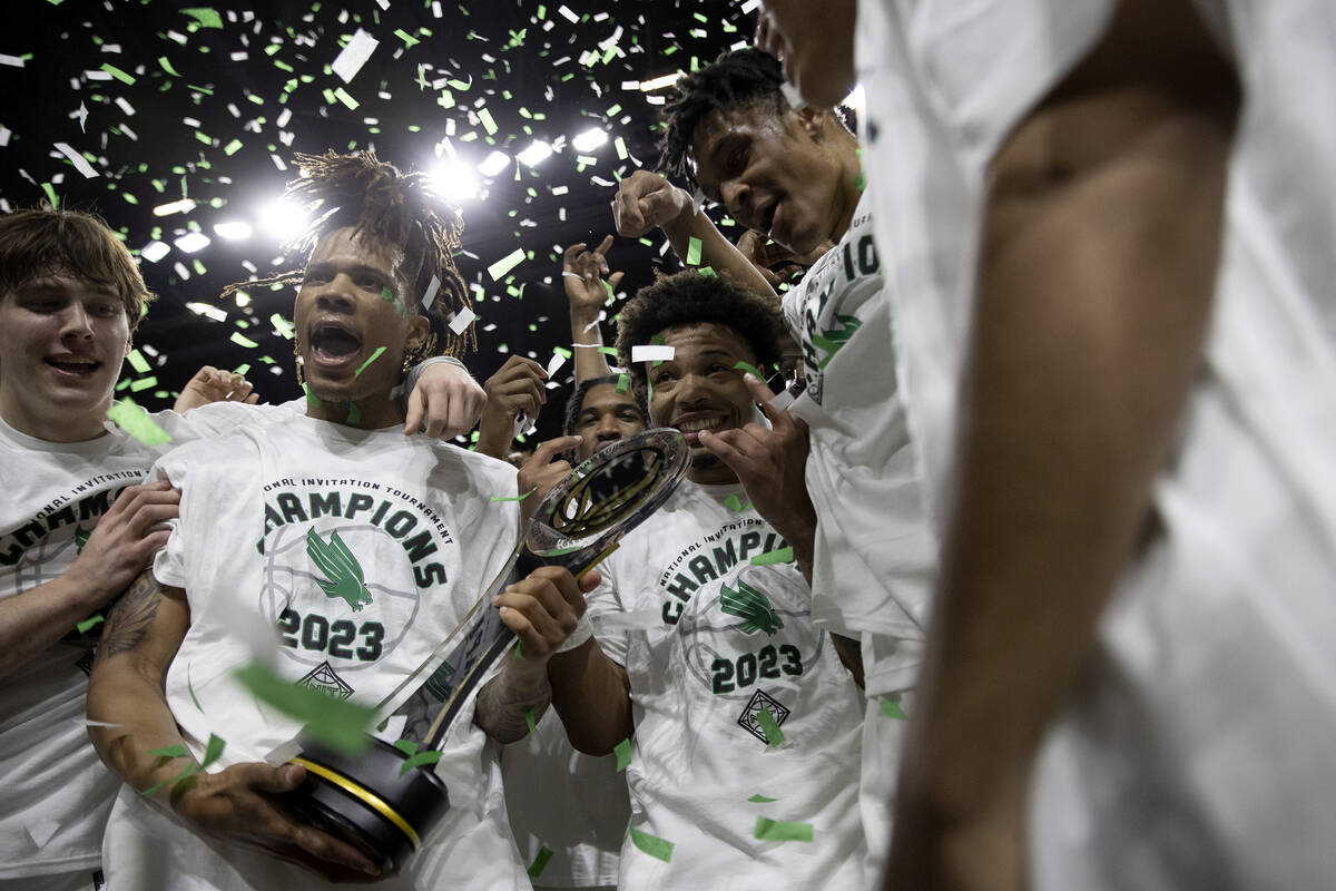 The North Texas Mean Green celebrate with their trophy after their team won the National Invita ...