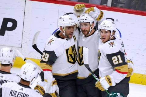 Vegas Golden Knights center Nicolas Roy (10) is congratulated on his goal by Alec Martinez (23) ...