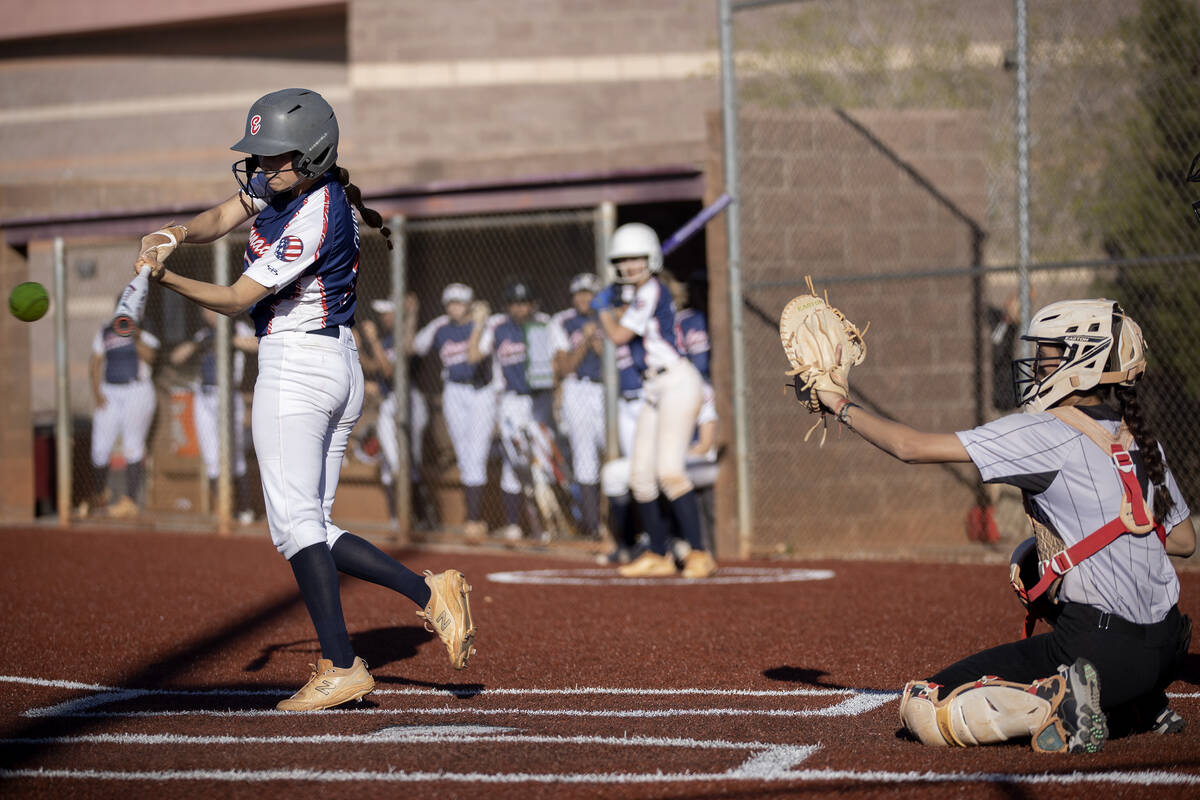 Coronado’s Paisley Magdaleno swings to hit while Faith Lutheran’s Jillian Molnar ...