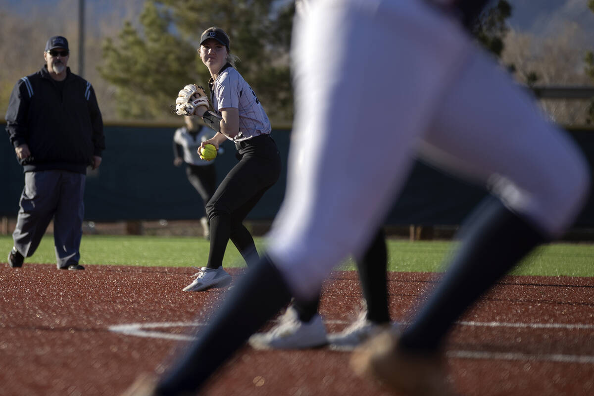 Faith Lutheran’s Amya Zacarias throws to first during a high school softball game agains ...
