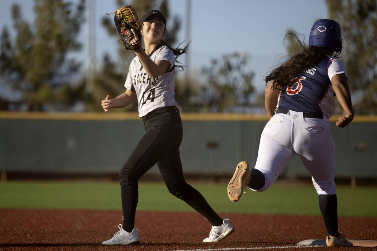 Faith Lutheran’s Averi O takes a step off first base and smiles after outing Coronado&#x ...