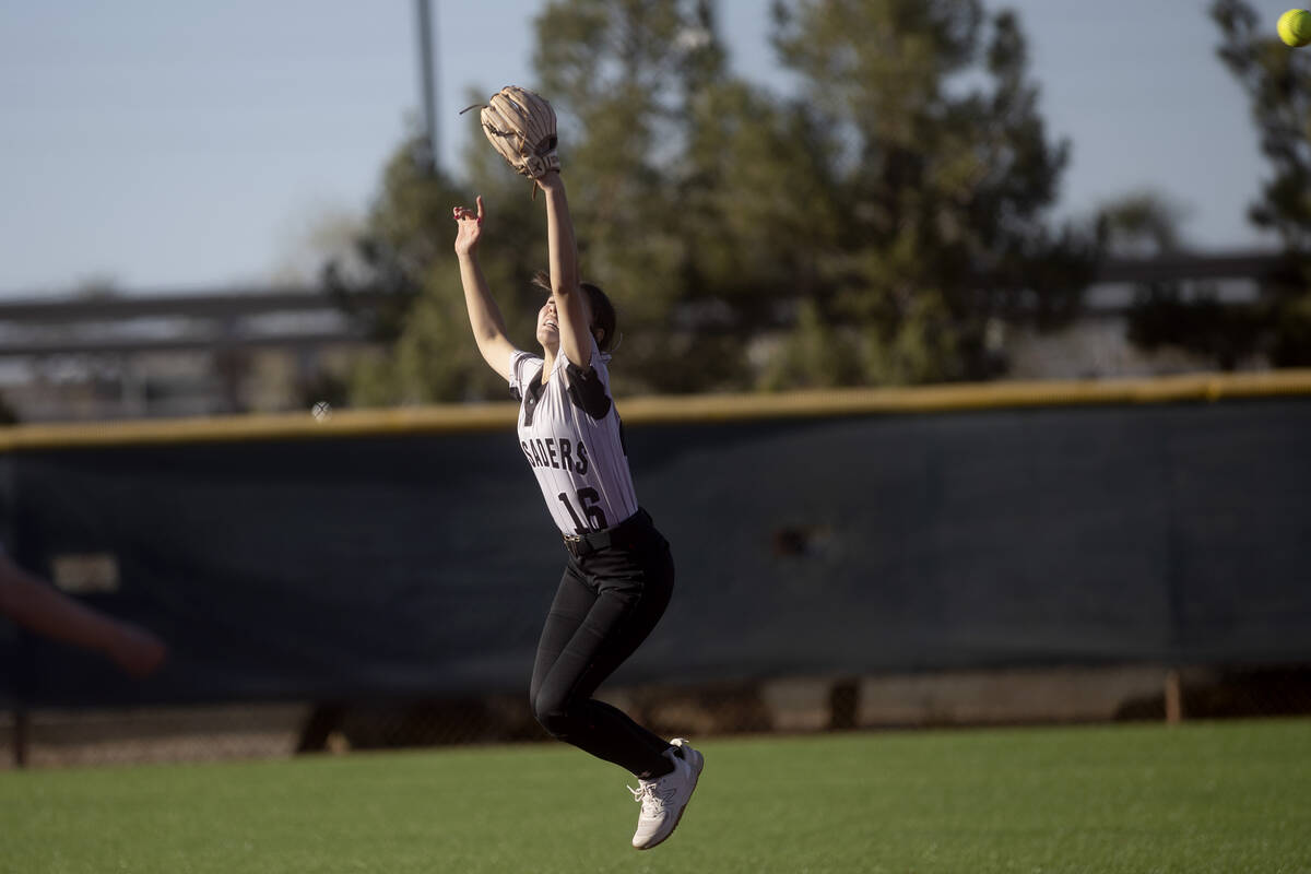 Faith Lutheran’s Shaylee Ghadery jumps but misses a catch during a high school softball ...