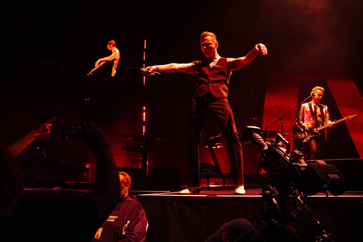 Dave Gahan, center, and Martin Gore, right, of Depeche Mode perform at T-Mobile Arena on Thursd ...