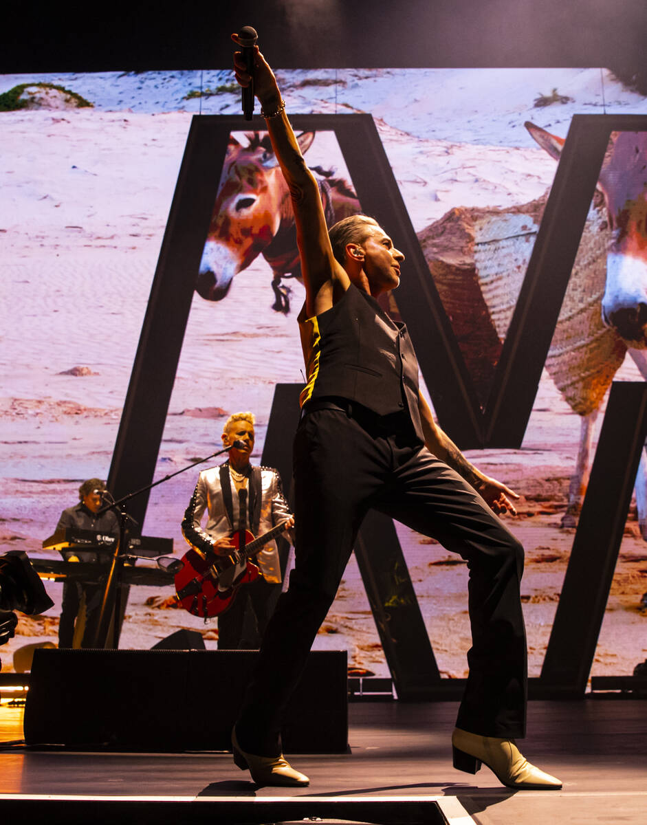 Dave Gahan, center, and Martin Gore, second from left, of Depeche Mode perform at T-Mobile Aren ...