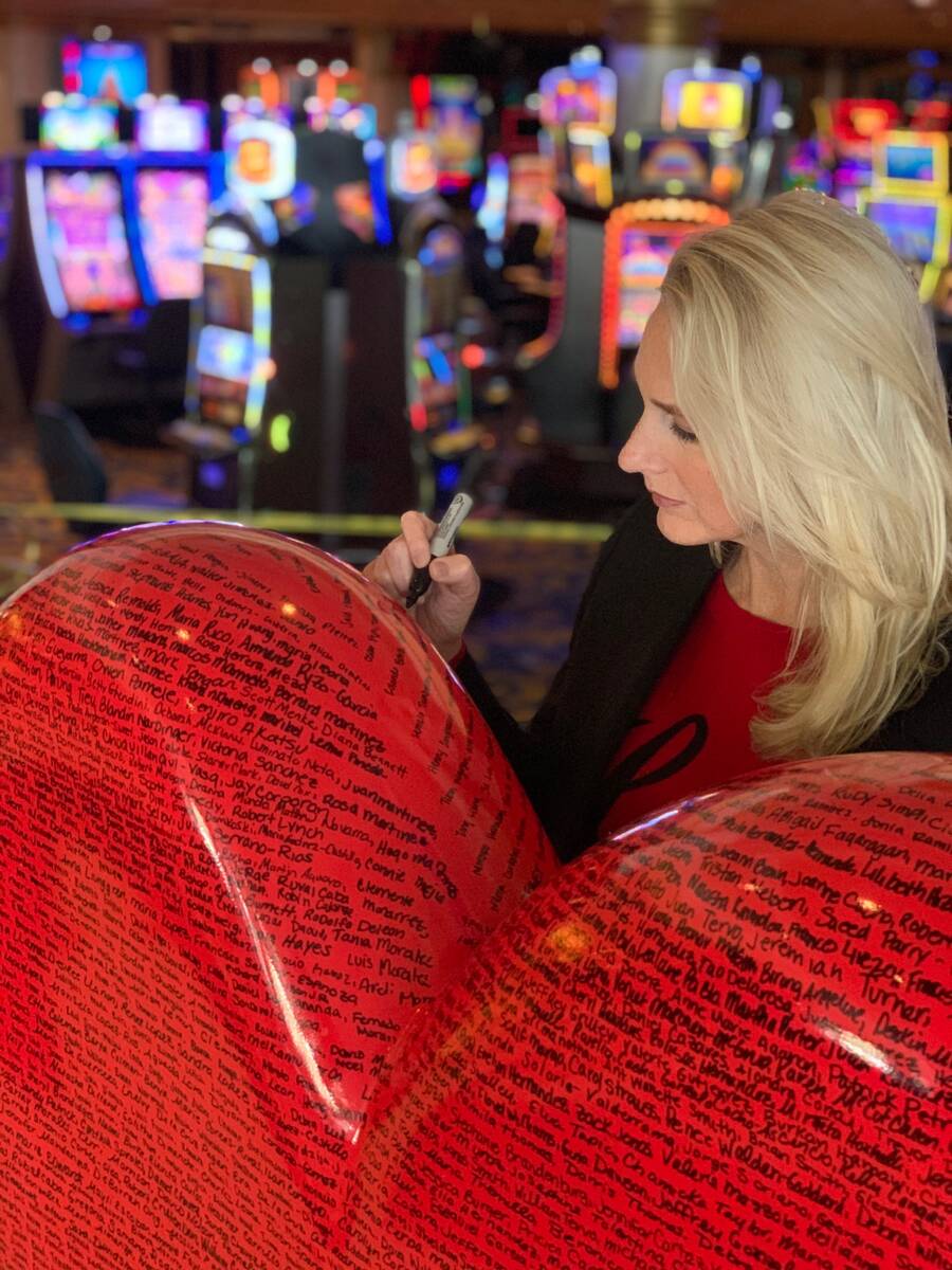 Westgate Las Vegas General Manager Cami Christensen is shown writing an employee's name to the ...