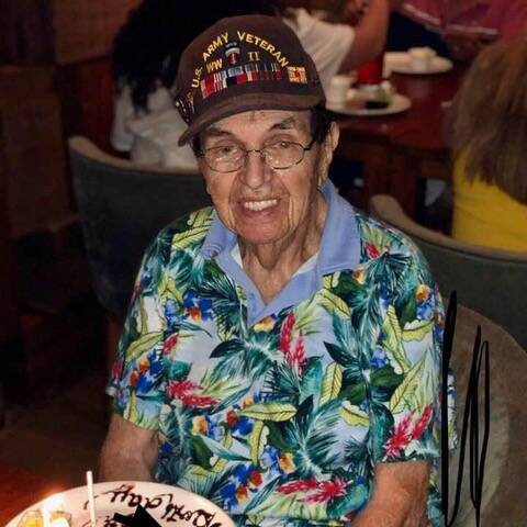 Herbert Muskin sits during a birthday celebration wearing his World War II Army veteran hat. (D ...