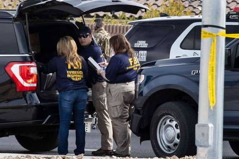 Members of the FBI's Evidence Support Team converse outside Matthew Beasley's home while negoti ...