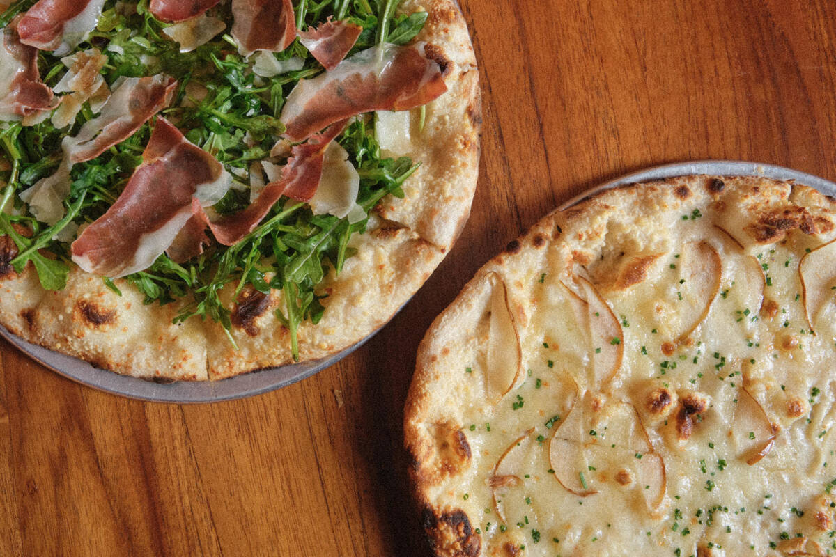 A bianca pizza with prosciutto di Parma and a pear and formaggio pizza are among the new spring ...