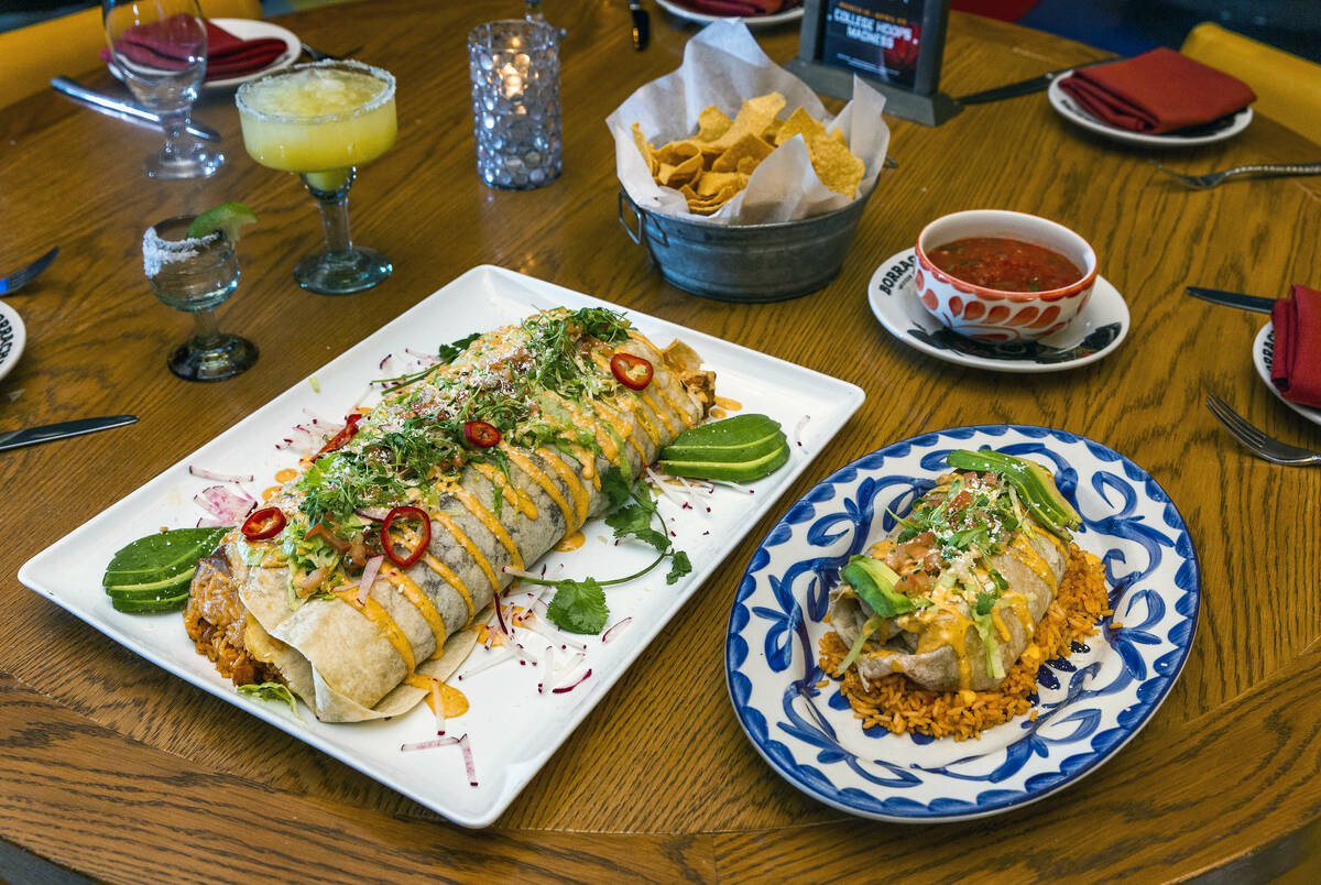 The 5-pound "Dos Manos" burrito, left, beside a regular sized Achiote Chicken burrito ...