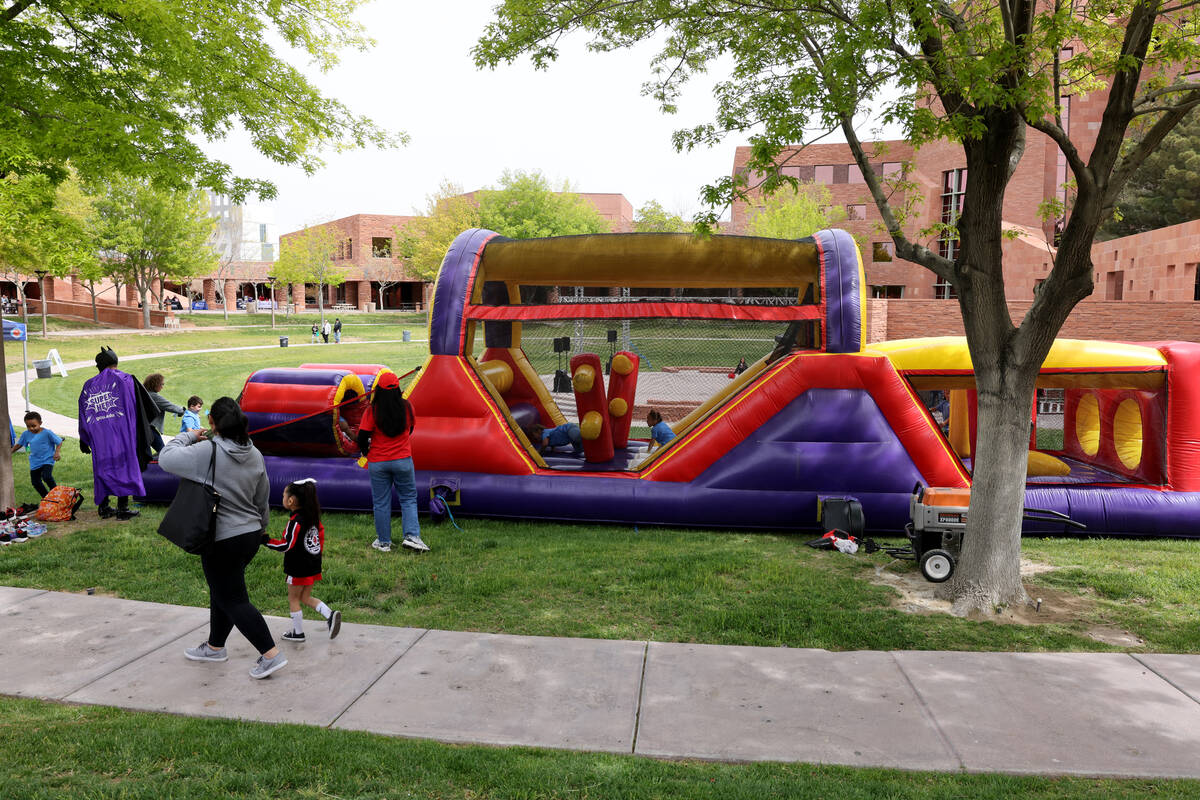 Unidentified foster children make their way through the bounce house obstacle course during a f ...