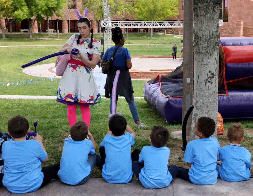 Unidentified foster children receive balloon creations from Liv Sheridan during a foster parent ...