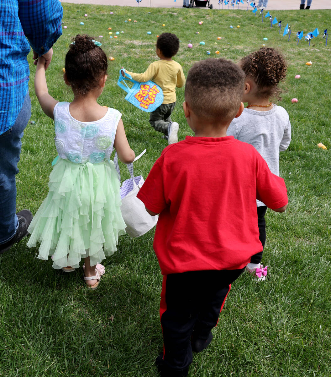 Unidentified foster children collect eggs during a hunt as part of a foster parent resource fai ...