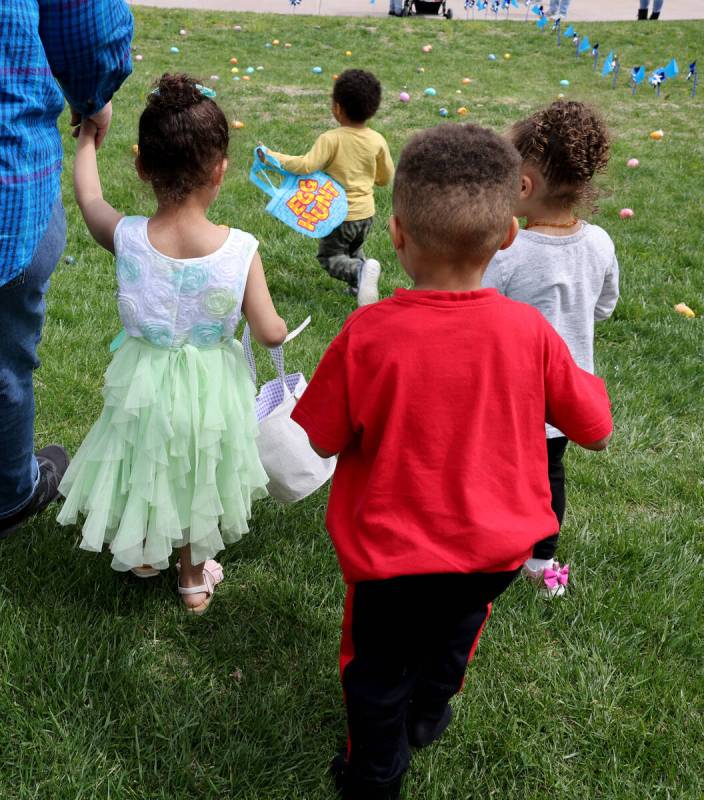 Unidentified foster children collect eggs during a hunt as part of a foster parent resource fai ...