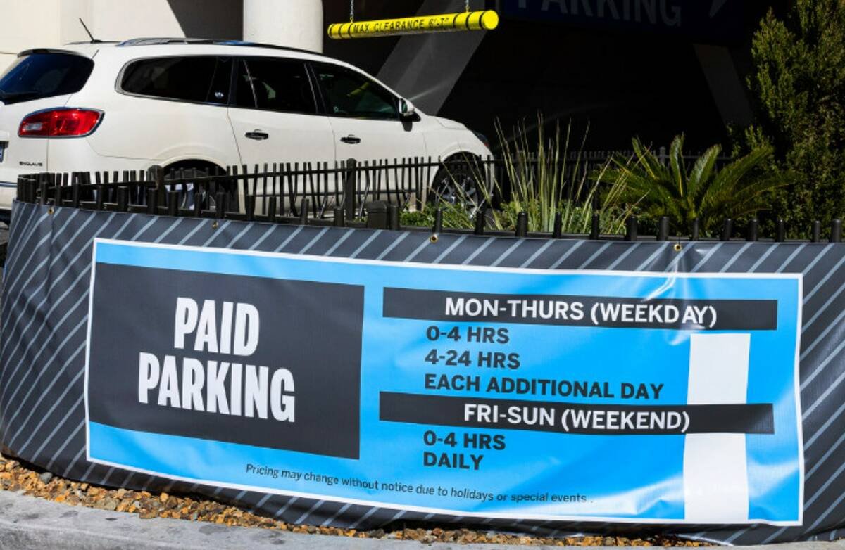 Paid parking sign is seen as a car enters a parking garage at The Strat in March 2023 in Las Ve ...