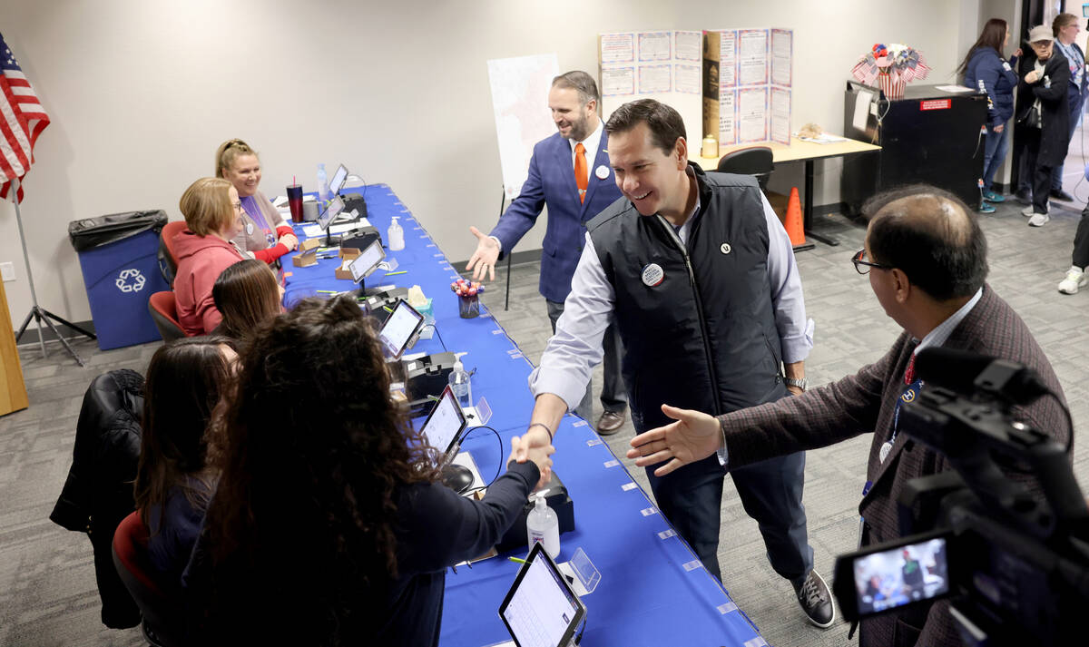 Nevada Secretary of State Cisco Aguilar, second from right, is introduced to poll workers by He ...