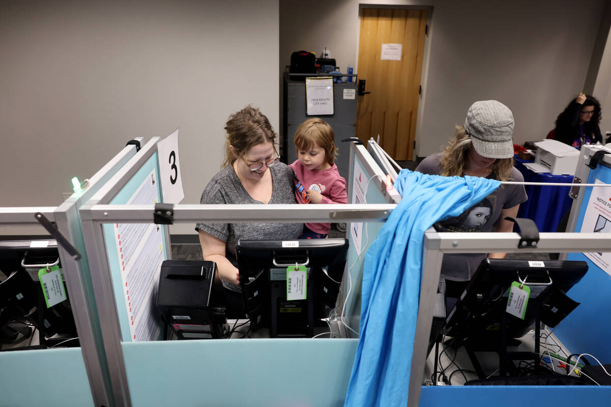 Shea Bishop, left, and her daughter Iris, 3, vote at Henderson City Hall during a special elect ...