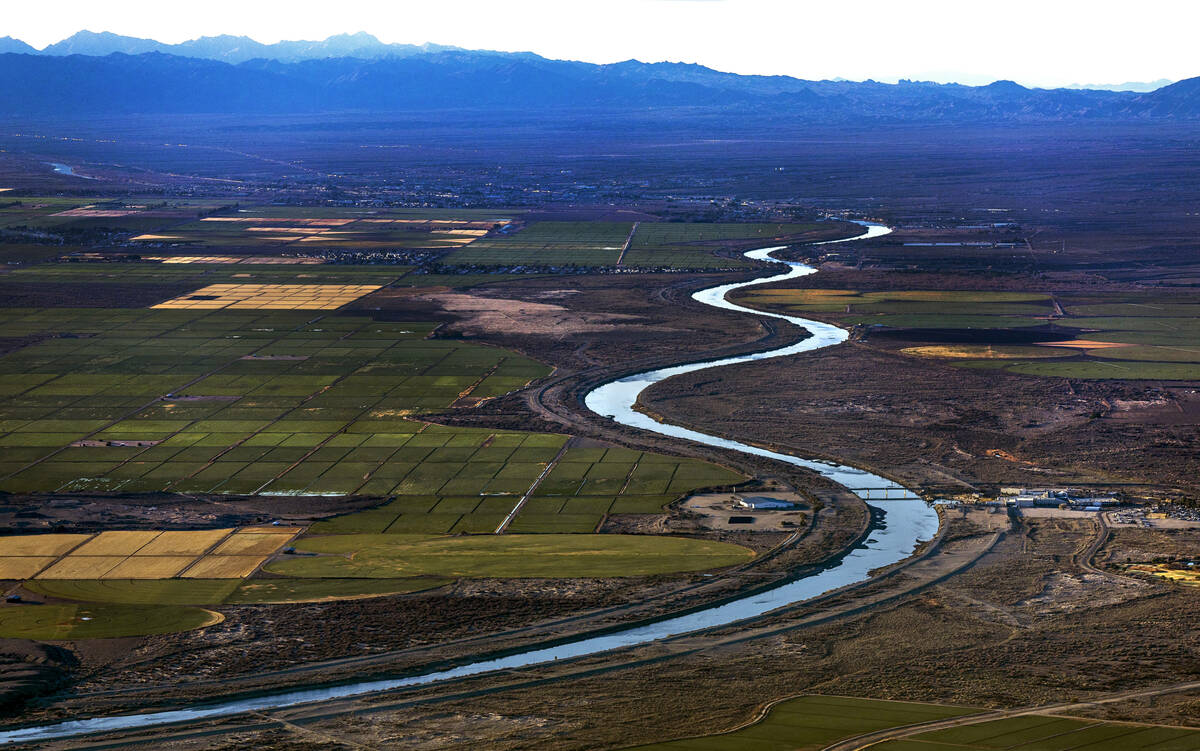 Morning lights Bullhead City, left, and Laughlin farm fields along the meandering Colorado Rive ...