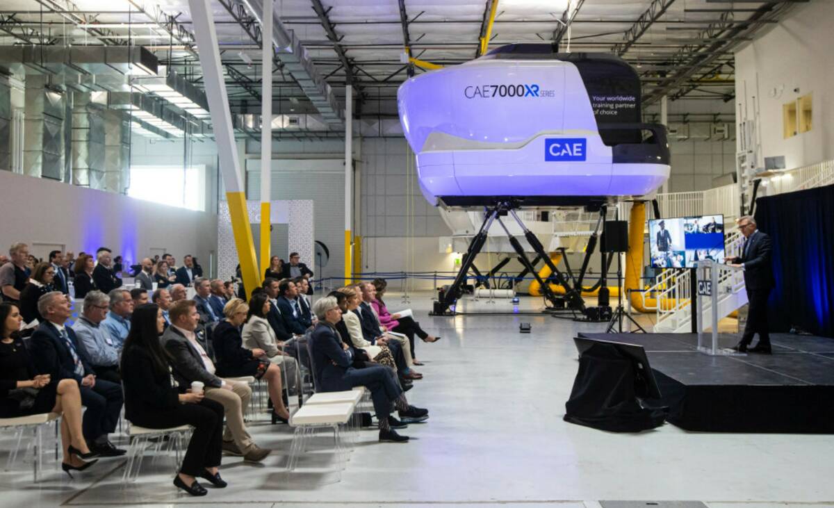 Marc Parent, president and CEO of CAE, right, speaks during a ribbon cutting ceremony for the c ...
