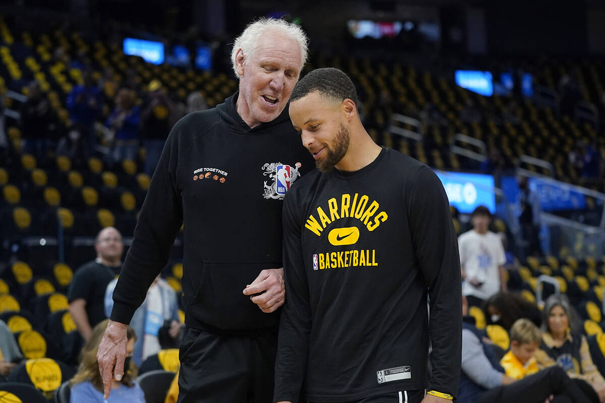 Hall of Fame basketball player Bill Walton, left, talks with Golden State Warriors guard Stephe ...