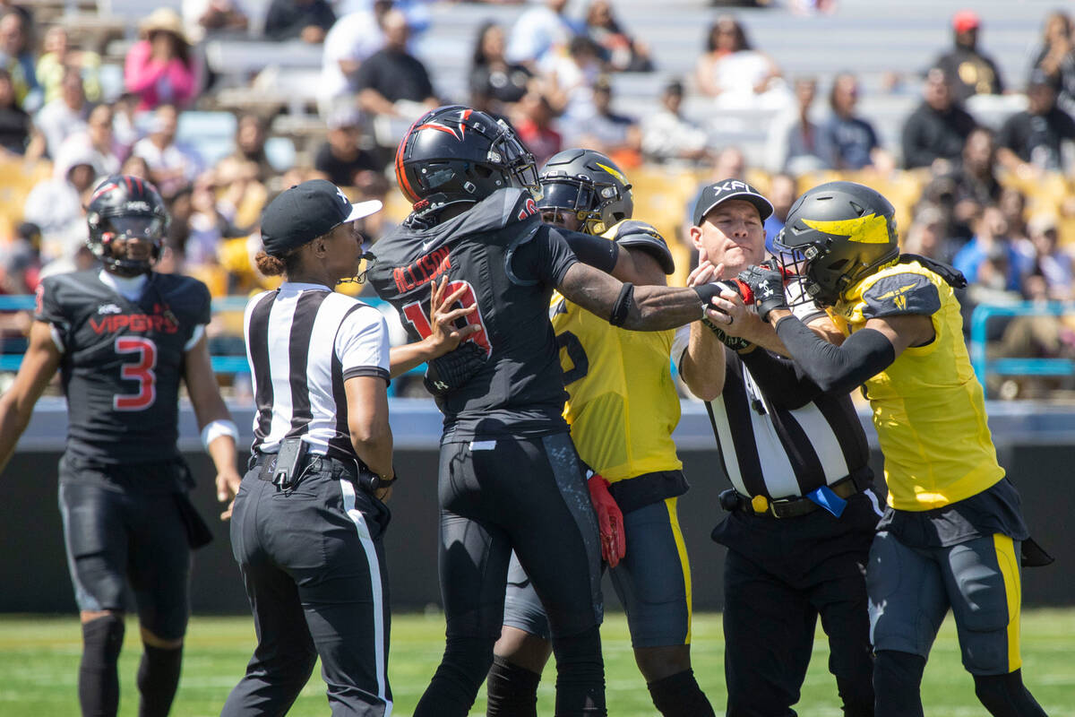 Referees try to break up an altercation between Vegas Vipers wide receiver Geronimo Allison (19 ...